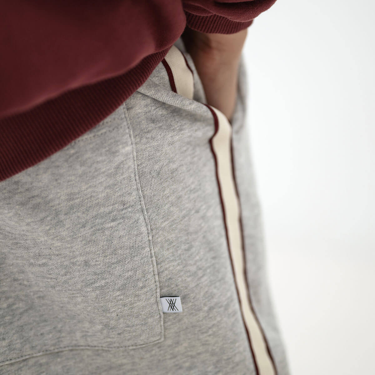 Pantalon de jogging ballon sportif gris clair chiné en coton biologique avec rayures latérales contrastantes et longueur 7/8 pour enfants de 2 à 14 ans